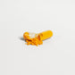 ViableSupps CoQ10 capsule broken open, showing vibrant yellow powder contents of the supplement.