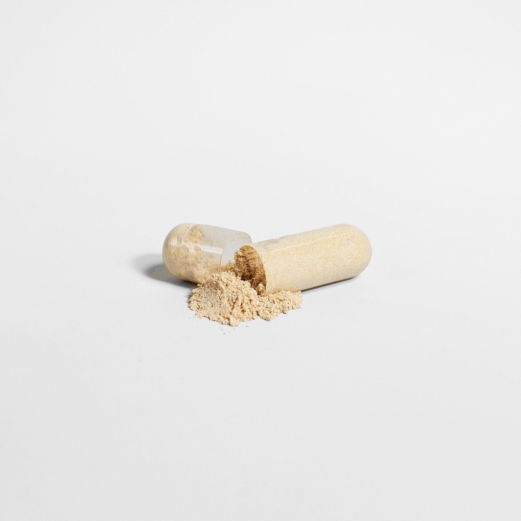 Open Viablesupps Ashwagandha capsule spilling organic powder, showcasing the natural supplement contents.