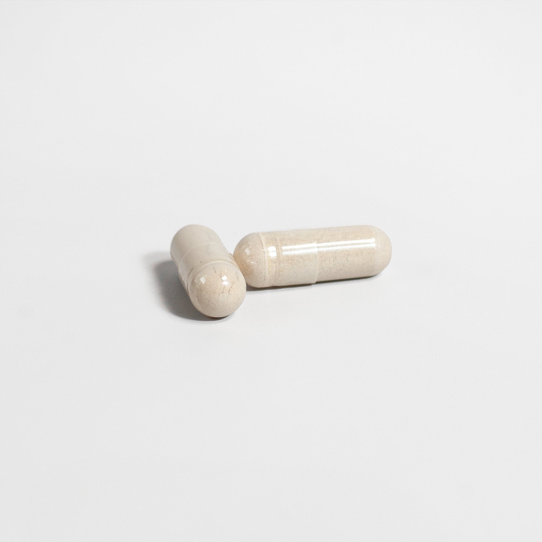 Close-up of two ViableSupps Testosterone Booster capsules on a plain white background.